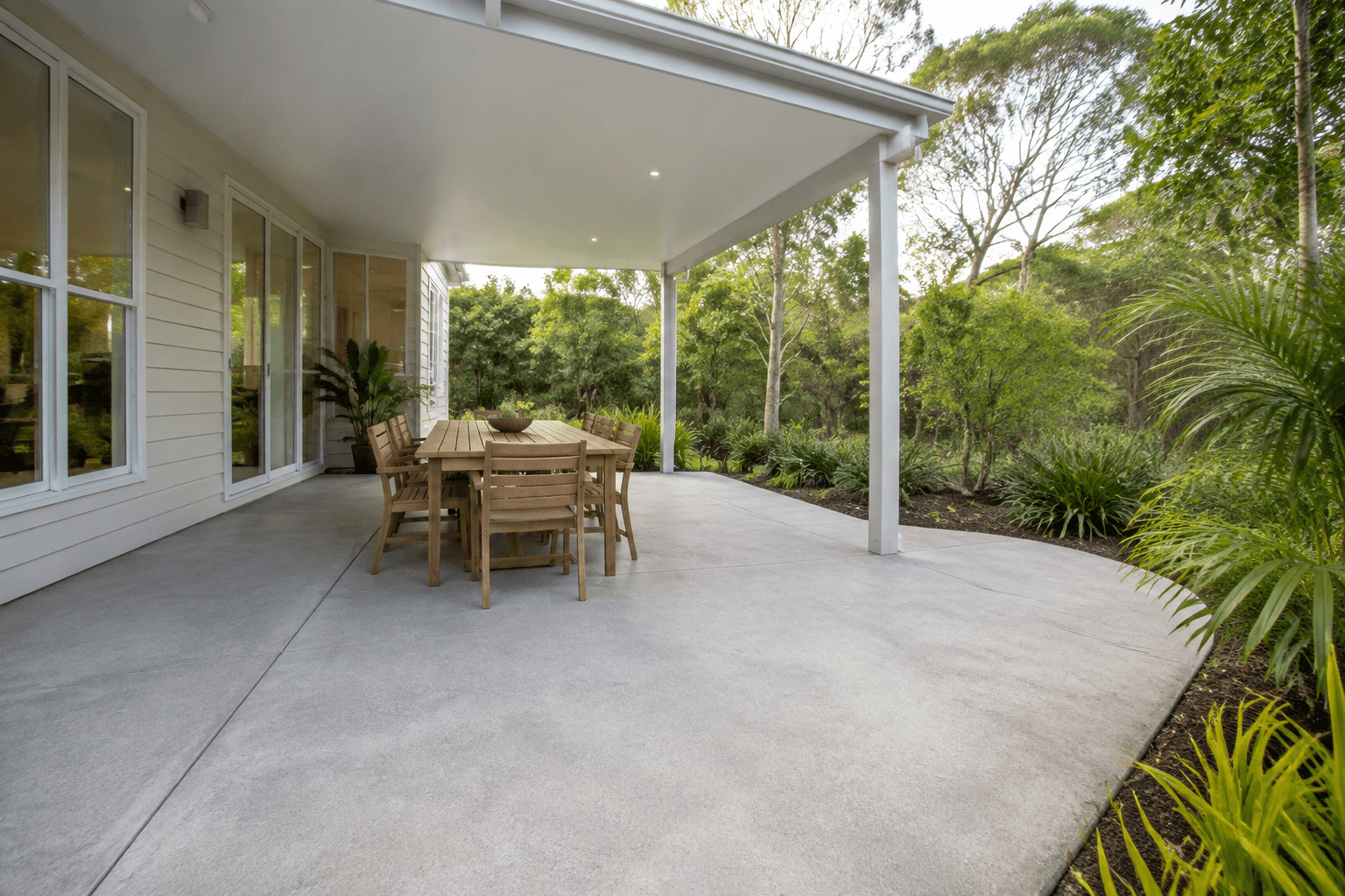 concrete outdoor entertaining terrace surrounded by subtropical planting